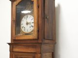 a grandfather clock that is in the corner of a room