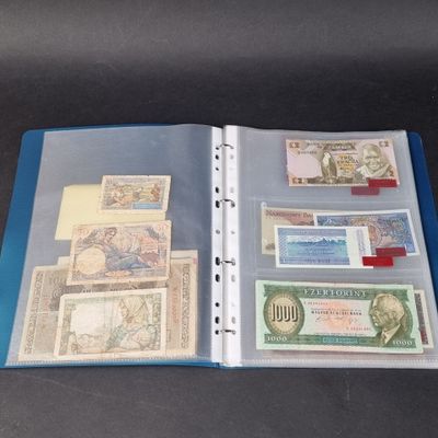 a binder with a lot of different currency on it