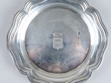 silver plate with scalloped edge on a white background