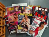 several magazines are stacked on top of each other on a table