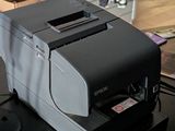 a printer sitting on top of a desk next to a computer mouse
