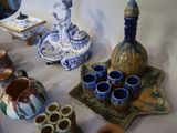 a table with a lot of vases and other items on it