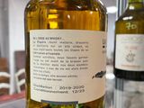 a bottle of olive oil on display in a glass case