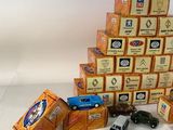 a pile of toy cars sitting on top of a pile of boxes