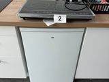 a small kitchen with a stove and a dishwasher on the counter