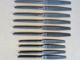 six pairs of scissors are lined up on a table