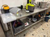 a table with a bunch of pots and pans on it