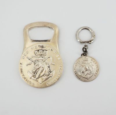 a close up of a bottle opener and a coin on a white surface