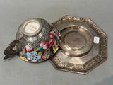 a silver plate with a flower design on it and a silver plate with a flower design on it