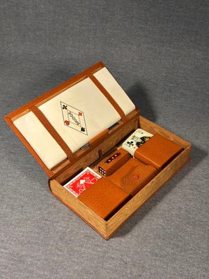 a small wooden box with cards and a watch in it