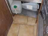 a picture of a kitchen with a sink and a blackboard