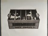 black and white photograph of a box with six bottles of wine in it
