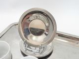 a silver tray with a silver plate on top of it