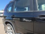 a black suv parked in a parking lot with other cars