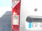 a silver van parked in a parking lot next to a building