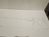 a white sheet of paper on a table with a pair of scissors on it