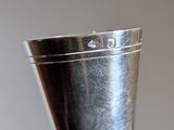 a silver cup that is sitting on top of a table