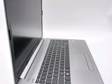 an open laptop computer sitting on top of a white surface