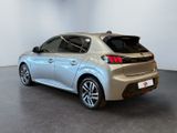 the rear end of a silver car in a white room