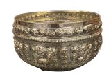 an old silver bowl with ornate designs on a white background