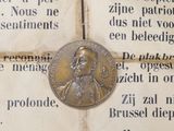 a coin on a piece of paper with a picture of a man