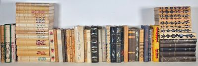 a lot of books that are on a shelf together
