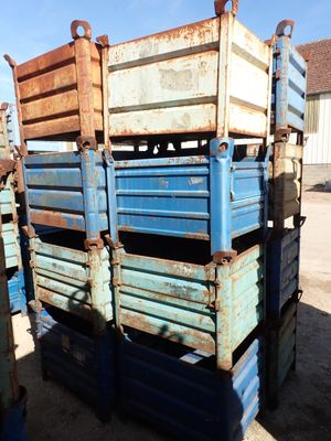 many crates stacked on top of each other in the dirt