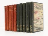 plusieurs vieux livres sont alignés sur une surface blanche
