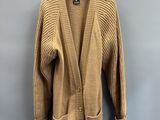 a tan cardigan sweater hanging on a hanger