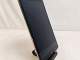 a tablet that is sitting on a stand on a table
