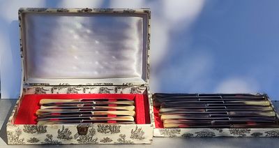 a box of pens and pencils sitting on top of a table