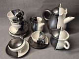 a lot of cups and saucers that are on the table
