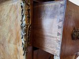 a wooden chest of drawers that has a drawer open