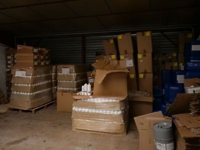 une grande quantité de cartons, les uns à côté des autres, dans un entrepôt