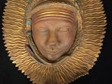 a close up of a statue of a person wearing a headdress