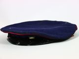 a blue hat with a red band on it