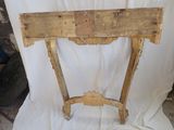 a small wooden table with a wooden top on a white cloth