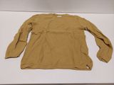 an image of a tan sweater on a white table