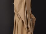 an image of a tan coat with a belt on a mannequin stand