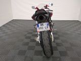 a motorcycle that is parked in a room with a checkered floor