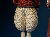 two figurines of a man and a woman dressed in red and white