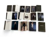 books of fashion and accessories are arranged on a white surface