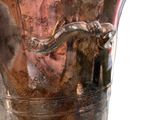 a silver vase with a handle on a white background