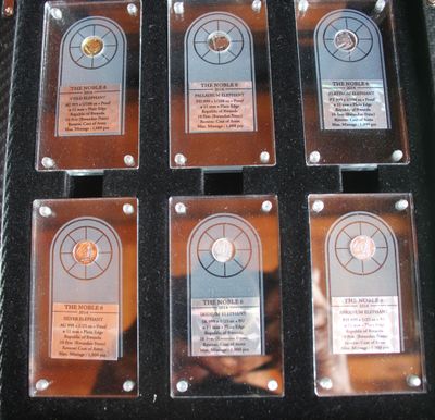 six plaques in a black case that are on display