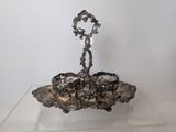 a silver plate on a glass table with a candle holder