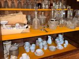 many different types of glassware on the shelves