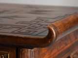a close up of a wooden table with a clock on top of it