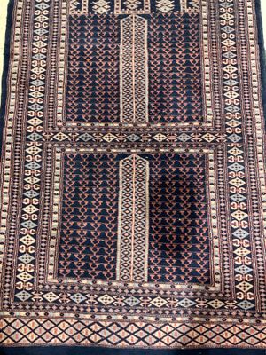 a close up of a rug on a wooden floor