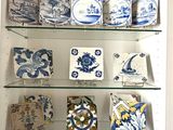 a glass shelf with blue and white plates on it