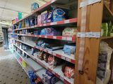 shelves in a grocery store filled with lots of food items
